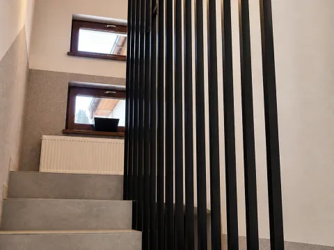 Wewnętrzna balustrada schodowa z pionowych stalowych lameli